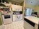 Cozy kitchen with white appliances, ample storage, and a view of the living area at 4753 Wild Iris Dr. # 301, Myrtle Beach, SC 29577
