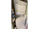 Efficient stacked washer and dryer unit maximizes space, with laundry supplies conveniently stored nearby at 4753 Wild Iris Dr. # 301, Myrtle Beach, SC 29577