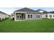 View of the back of the home featuring siding, a covered patio, and a lush lawn at 4846 Hopespring St., Myrtle Beach, SC 29579