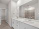 Elegant bathroom with double sinks, large mirrors, and a tiled shower at 4846 Hopespring St., Myrtle Beach, SC 29579