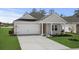 Charming single-story home with a gray exterior, well-manicured lawn, and a two-car garage at 4846 Hopespring St., Myrtle Beach, SC 29579