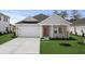 Charming single-story home with a gray exterior, well-manicured lawn, and a two-car garage at 4846 Hopespring St., Myrtle Beach, SC 29579