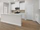 Kitchen featuring stainless steel appliances, white cabinets, and a central island with a sink at 4846 Hopespring St., Myrtle Beach, SC 29579