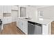 Kitchen island features a stainless dishwasher, a sink, and white cabinets at 4846 Hopespring St., Myrtle Beach, SC 29579