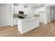 Spacious kitchen with white cabinets, stainless appliances, and a large center island at 4846 Hopespring St., Myrtle Beach, SC 29579