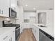 Stylish kitchen featuring white cabinetry, a tiled backsplash, and stainless-steel appliances at 4846 Hopespring St., Myrtle Beach, SC 29579