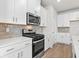 Well-equipped kitchen with white cabinets, stainless steel appliances, and ample counter space at 4846 Hopespring St., Myrtle Beach, SC 29579