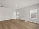 A well-lit room with three windows and wood-look flooring creates an inviting atmosphere at 4846 Hopespring St., Myrtle Beach, SC 29579