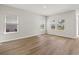 Bright living room with wood-look flooring and lots of natural light from the three windows at 4846 Hopespring St., Myrtle Beach, SC 29579