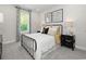 Cozy bedroom with a metal bed frame, soft textures, and large window providing natural light at 4877 Hopespring St., Myrtle Beach, SC 29579