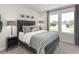 Well-lit bedroom with a statement headboard, decorative footballs, and a large window with a view at 4877 Hopespring St., Myrtle Beach, SC 29579