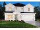 Charming two-story home with a white board and batten exterior and well-manicured front lawn at 4877 Hopespring St., Myrtle Beach, SC 29579