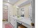 Bathroom featuring white cabinets, hard flooring, a large vanity and framed mirror at 504 Sea Vista Ln., North Myrtle Beach, SC 29582