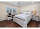 Bedroom featuring hardwood flooring, white shutters, a ceiling fan, and a queen sized bed at 504 Sea Vista Ln., North Myrtle Beach, SC 29582