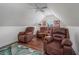 Attic bonus room featuring hardwood flooring, a ceiling fan, and three brown leather recliners at 504 Sea Vista Ln., North Myrtle Beach, SC 29582