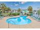 Inviting community pool and spa area surrounded by lounge chairs, lush landscaping, and resort-style amenities at 504 Sea Vista Ln., North Myrtle Beach, SC 29582