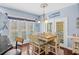 Bright dining area with a table for six, shutters, and natural light through the windows at 504 Sea Vista Ln., North Myrtle Beach, SC 29582