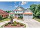 Charming two-story home with a well-manicured lawn, a two-car garage, and a welcoming front porch at 504 Sea Vista Ln., North Myrtle Beach, SC 29582