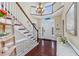 Grand foyer with hardwood floors, staircase, chandelier, and plenty of natural light at 504 Sea Vista Ln., North Myrtle Beach, SC 29582