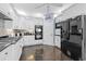Bright kitchen with white cabinets, black appliances, and a decorative bicycle accent at 504 Sea Vista Ln., North Myrtle Beach, SC 29582