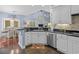 Stylish kitchen featuring white cabinets, granite countertops, and stainless steel appliances at 504 Sea Vista Ln., North Myrtle Beach, SC 29582