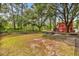 Expansive yard with fire pit, mature trees, and unique red outbuilding at 5114 Cowart Ct., Murrells Inlet, SC 29576