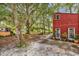 Spacious backyard with mature trees and a unique two-story red building at 5114 Cowart Ct., Murrells Inlet, SC 29576