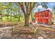 View of a large tree in the backyard with a red two-story building at 5114 Cowart Ct., Murrells Inlet, SC 29576