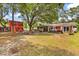Wide shot of the backyard with multiple buildings and a hot tub at 5114 Cowart Ct., Murrells Inlet, SC 29576