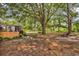 Large backyard with mature trees, a seating area, and a vegetable garden at 5114 Cowart Ct., Murrells Inlet, SC 29576