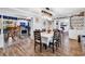 Dining room featuring hardwood floors, an elegant light fixture, and views into the kitchen and living room at 5114 Cowart Ct., Murrells Inlet, SC 29576