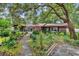 Charming home featuring brick exterior with lush landscaping, a stone walkway, and a screened in porch at 5114 Cowart Ct., Murrells Inlet, SC 29576