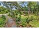 Lush garden featuring a wooden pergola and various plants, creating a serene outdoor space at 5114 Cowart Ct., Murrells Inlet, SC 29576
