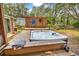 Outdoor hot tub on wooden deck with decorative sun wall art at 5114 Cowart Ct., Murrells Inlet, SC 29576