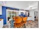 Kitchen featuring blue walls, an island with chairs, a pantry, and access to the screened in porch at 5114 Cowart Ct., Murrells Inlet, SC 29576