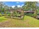 Backyard pergola surrounded by lush landscaping, offering a peaceful outdoor setting at 5114 Cowart Ct., Murrells Inlet, SC 29576