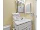 Bright bathroom features a white vanity with ample storage, silver hardware, a silver-framed mirror and a mounted hair dryer at 5905 S Kings Hwy. # 206A, Myrtle Beach, SC 29575