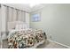 Comfortable bedroom with a queen-size bed, light green walls and bright floral comforter at 5905 S Kings Hwy. # 206A, Myrtle Beach, SC 29575