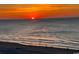 Stunning ocean sunset with a beautiful beach and silhouettes of people walking along the shore at 5905 S Kings Hwy. # 206A, Myrtle Beach, SC 29575