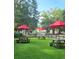 Serene picnic area with red umbrellas and green grass is perfect for outdoor relaxation and dining at 5905 S Kings Hwy. # 206A, Myrtle Beach, SC 29575