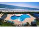 An expansive pool with an ocean view, featuring plenty of lounge chairs at 5905 S Kings Hwy. # 206A, Myrtle Beach, SC 29575