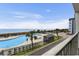 Scenic view from the balcony overlooking a large pool, beach, and ocean creating a desirable vacation spot at 5905 S Kings Hwy. # 206A, Myrtle Beach, SC 29575