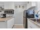 Efficient kitchen with white cabinets, stainless steel appliances and speckled granite countertops at 5909 N Ocean Blvd. # 18, North Myrtle Beach, SC 29582