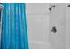 Clean shower space with white marble tile, shower head, and a curtain with blue details at 5909 N Ocean Blvd. # 18, North Myrtle Beach, SC 29582