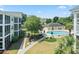 A view of the community pool, lush landscaping and condo buildings from an upper level at 601 Hillside Dr. N # 1931, North Myrtle Beach, SC 29582
