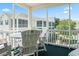 Relaxing balcony view with white Adirondack chairs and table overlooking a courtyard and other condo buildings at 601 Hillside Dr. N # 1931, North Myrtle Beach, SC 29582