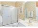 Bathroom showcasing shower with glass doors, palm-themed wallpaper, and a white vanity at 601 Hillside Dr. N # 1931, North Myrtle Beach, SC 29582