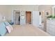 Comfortable bedroom showing closet, ensuite bathroom, dresser, and a glimpse into the living room at 601 Hillside Dr. N # 1931, North Myrtle Beach, SC 29582
