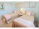 This bedroom features comfortable twin beds, coastal themed wall art, and ensuite bathroom access at 601 Hillside Dr. N # 1931, North Myrtle Beach, SC 29582