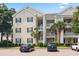 Inviting condo building featuring palm trees, well-manicured landscaping, and convenient parking at 601 Hillside Dr. N # 1931, North Myrtle Beach, SC 29582